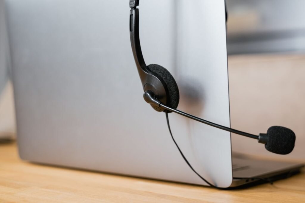 A laptop with a headset attached, ideal for virtual meetings or online customer support.